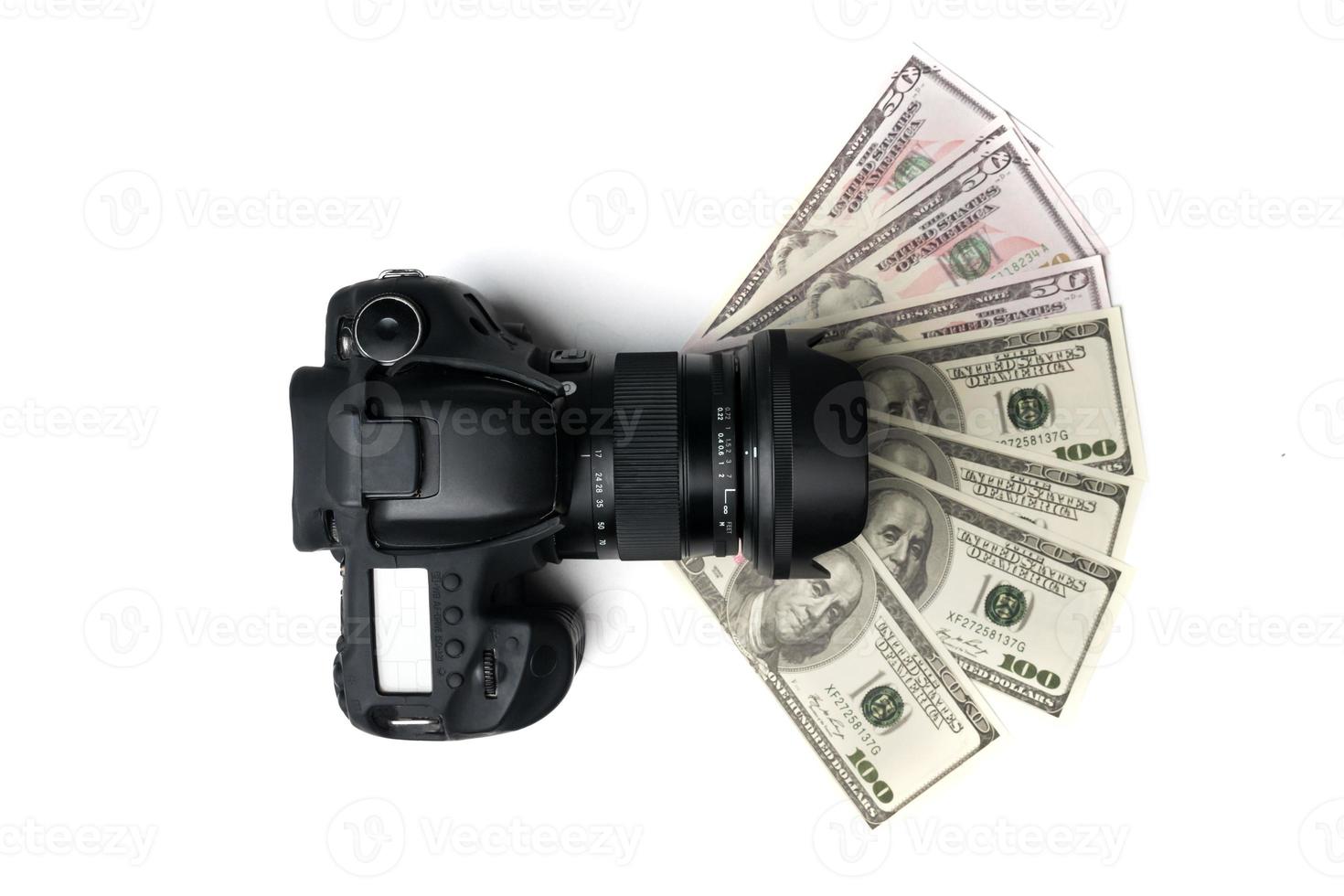 Top view of a black digital camera on banknotes with white background. photo