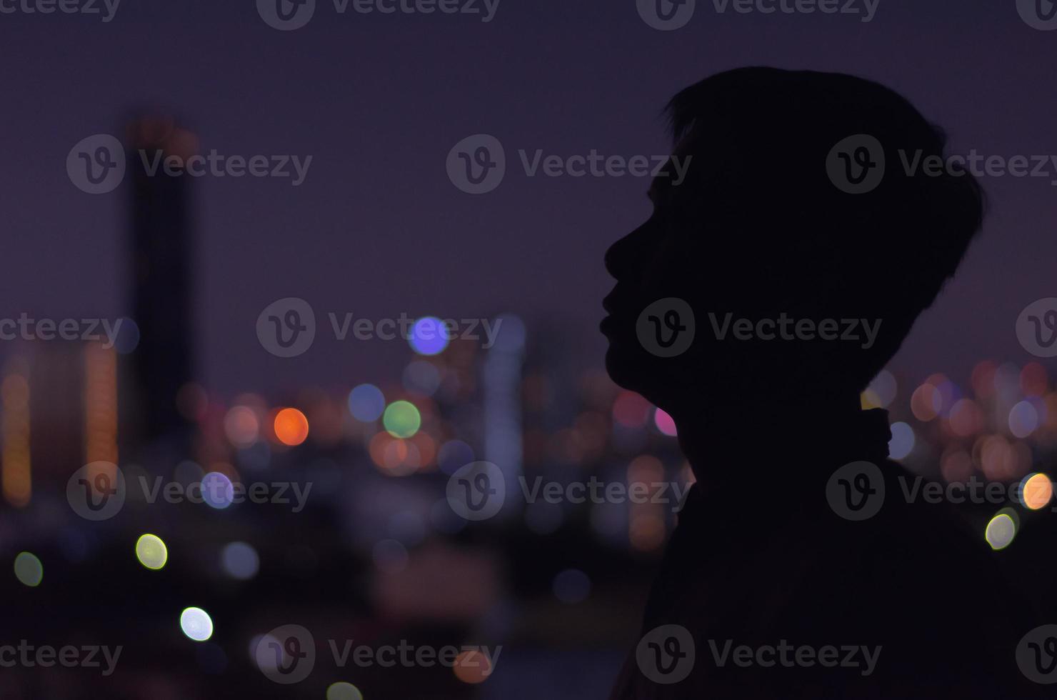 A man standing in darkness alone. photo