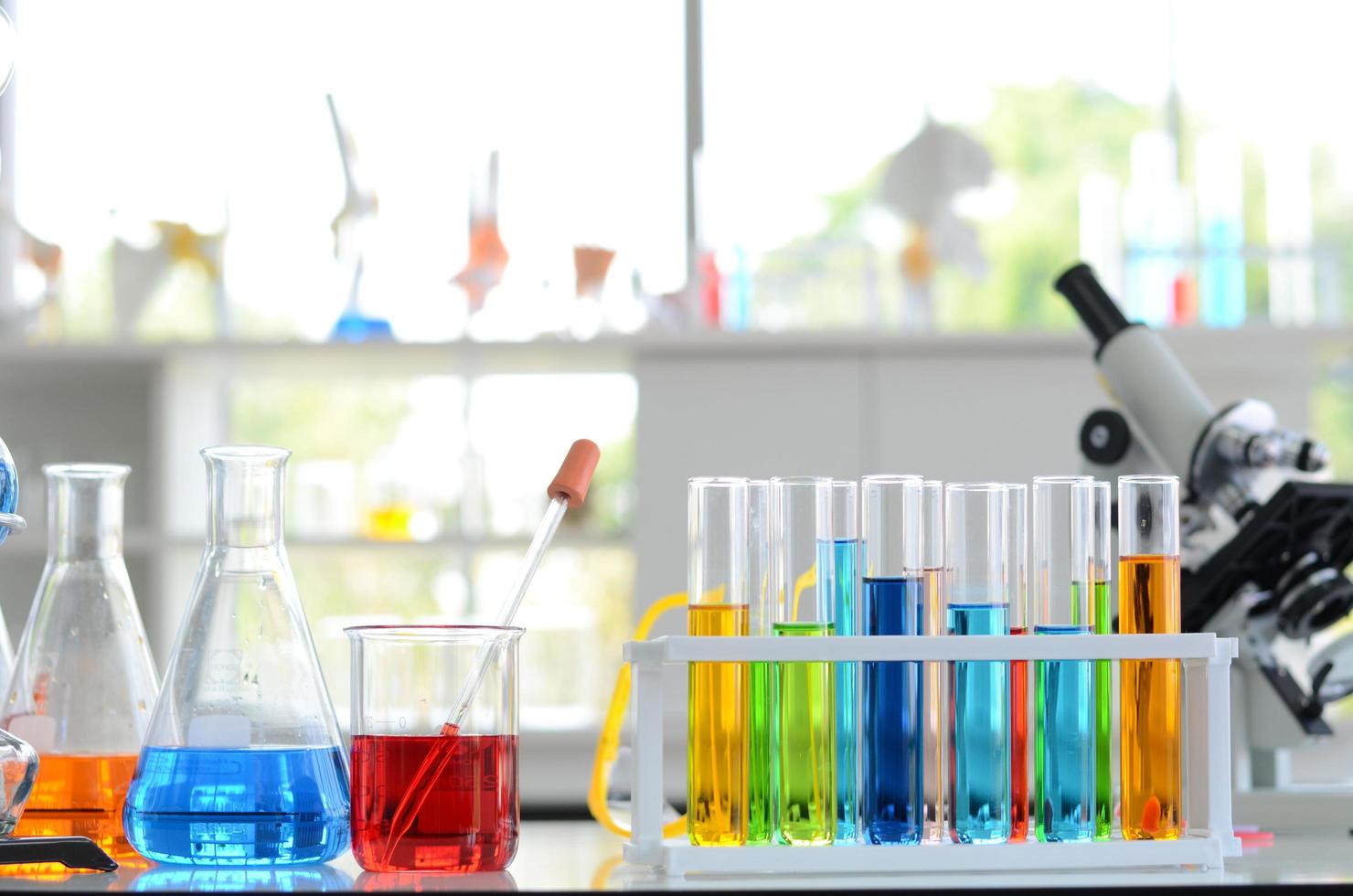 Chemical Liquid test tube and Microscope in Laboratory. photo