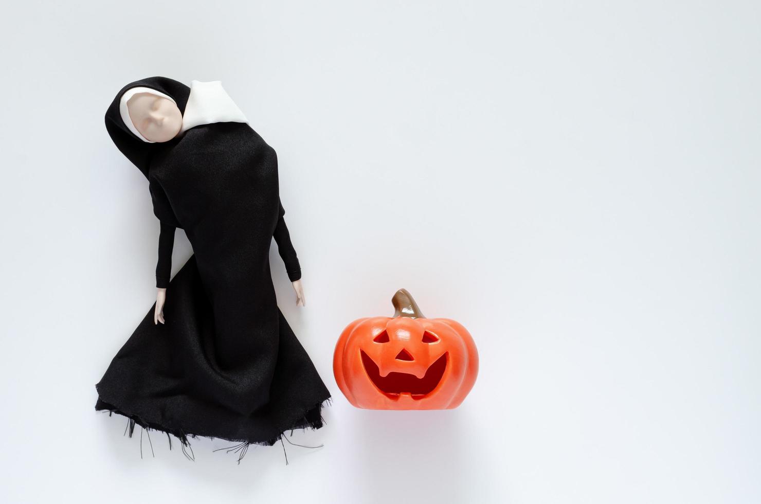 Scary nun ghost that the head at shoulder and no mouth with pumpkin. Halloween minimal concept. photo