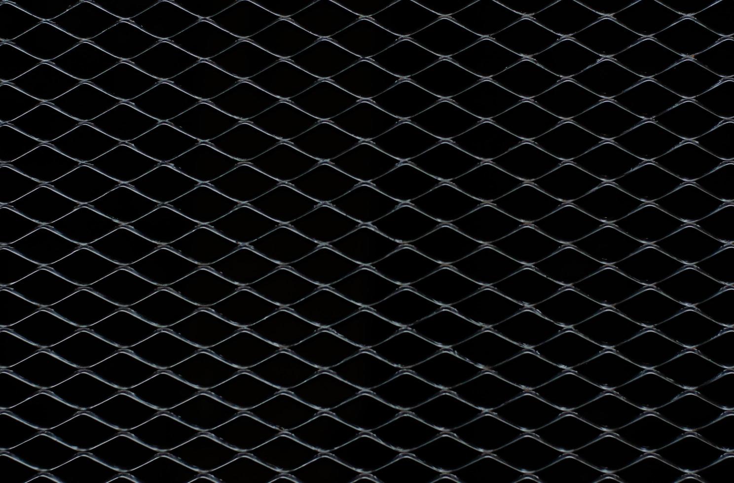 Dark gray and silver grid of metal fence that taking as background. photo