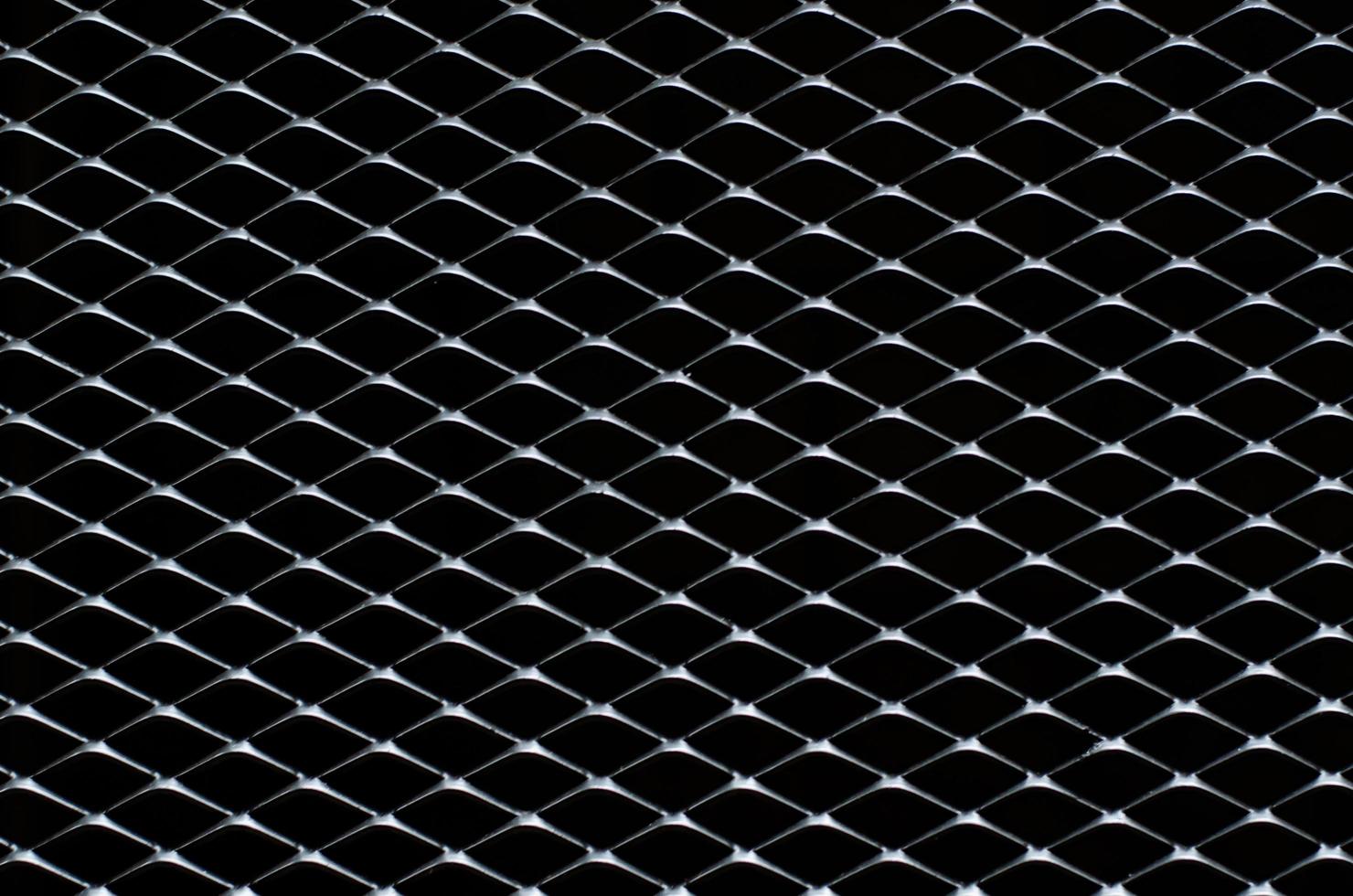 Dark gray and silver grid of metal fence that taking as background. photo