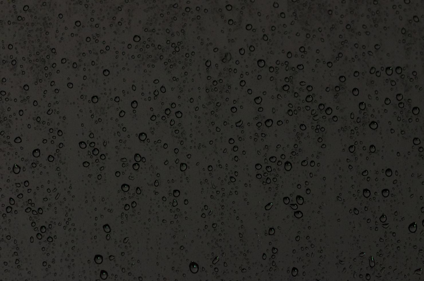 Focus and blurred photo of Rain drop on glass window with dark color for abstract and background concept.