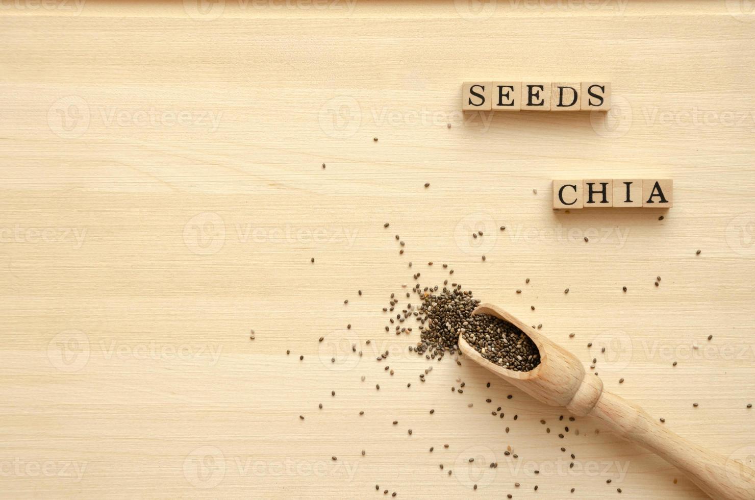 Chia seeds on a wooden board with a spoon and an inscription, photo