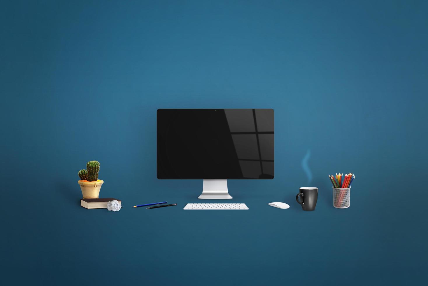 Computer display surrounded by office supplies on blue background. Clean screen for web page promotion photo