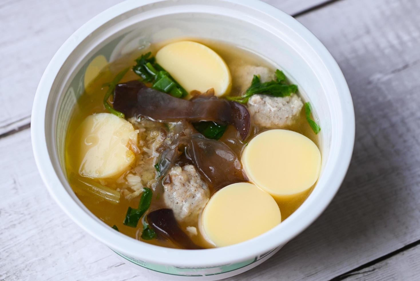 clear soup bowl with pork jelly mushroom black jelly fungus vegetable and celery , vermicelli soup menu healthy food egg tofu soup photo