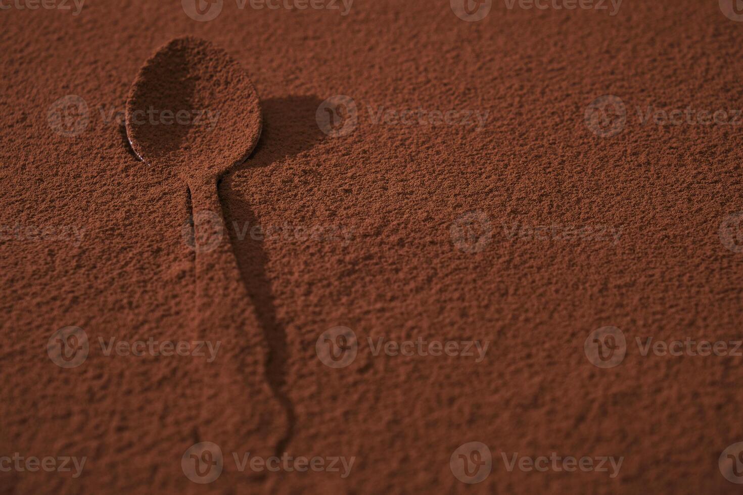 Tablespoon is completely covered with cocoa powder. Confectionery and cooking. 9336771 Stock