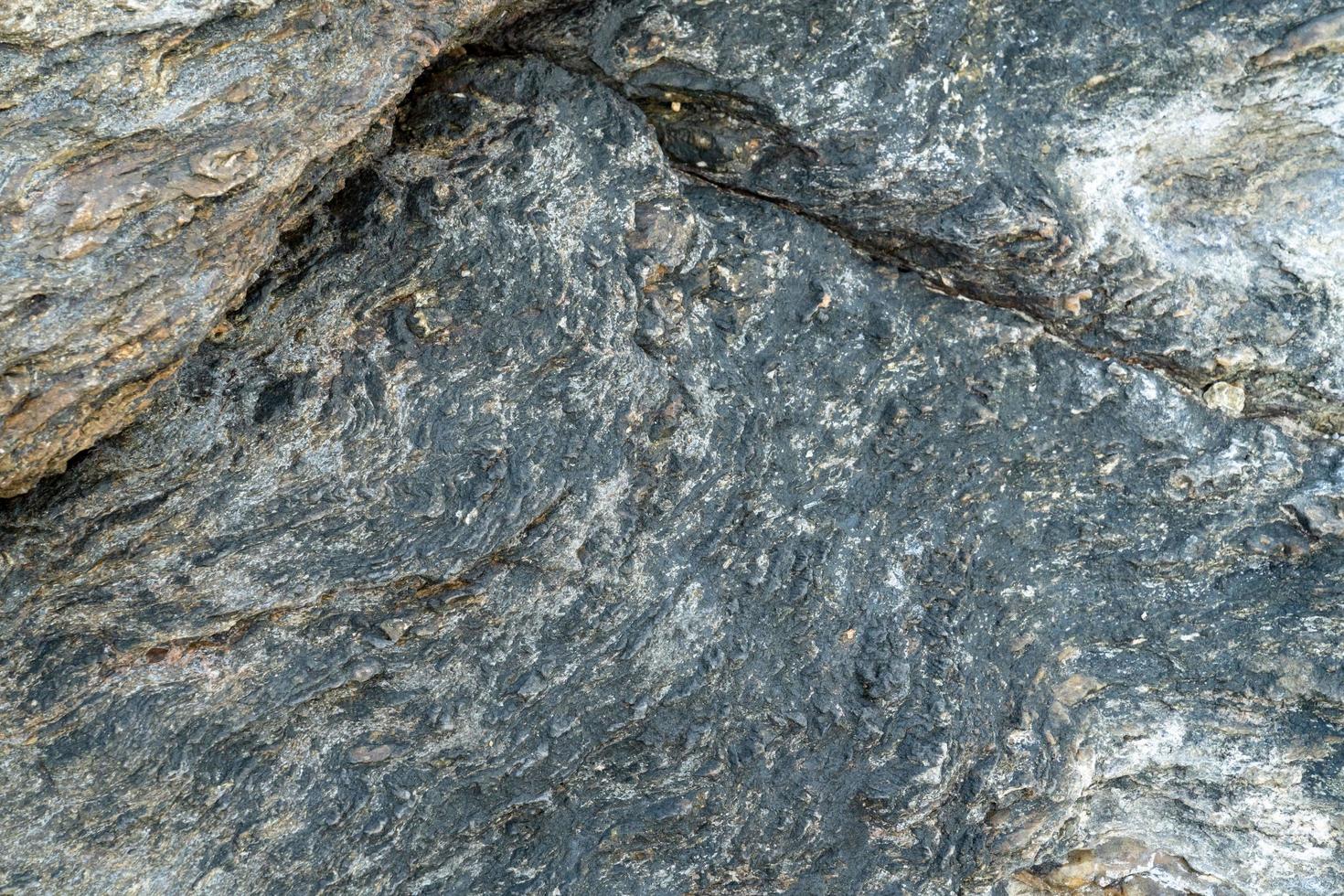 Primer plano de fondo de roca ígnea gris foto