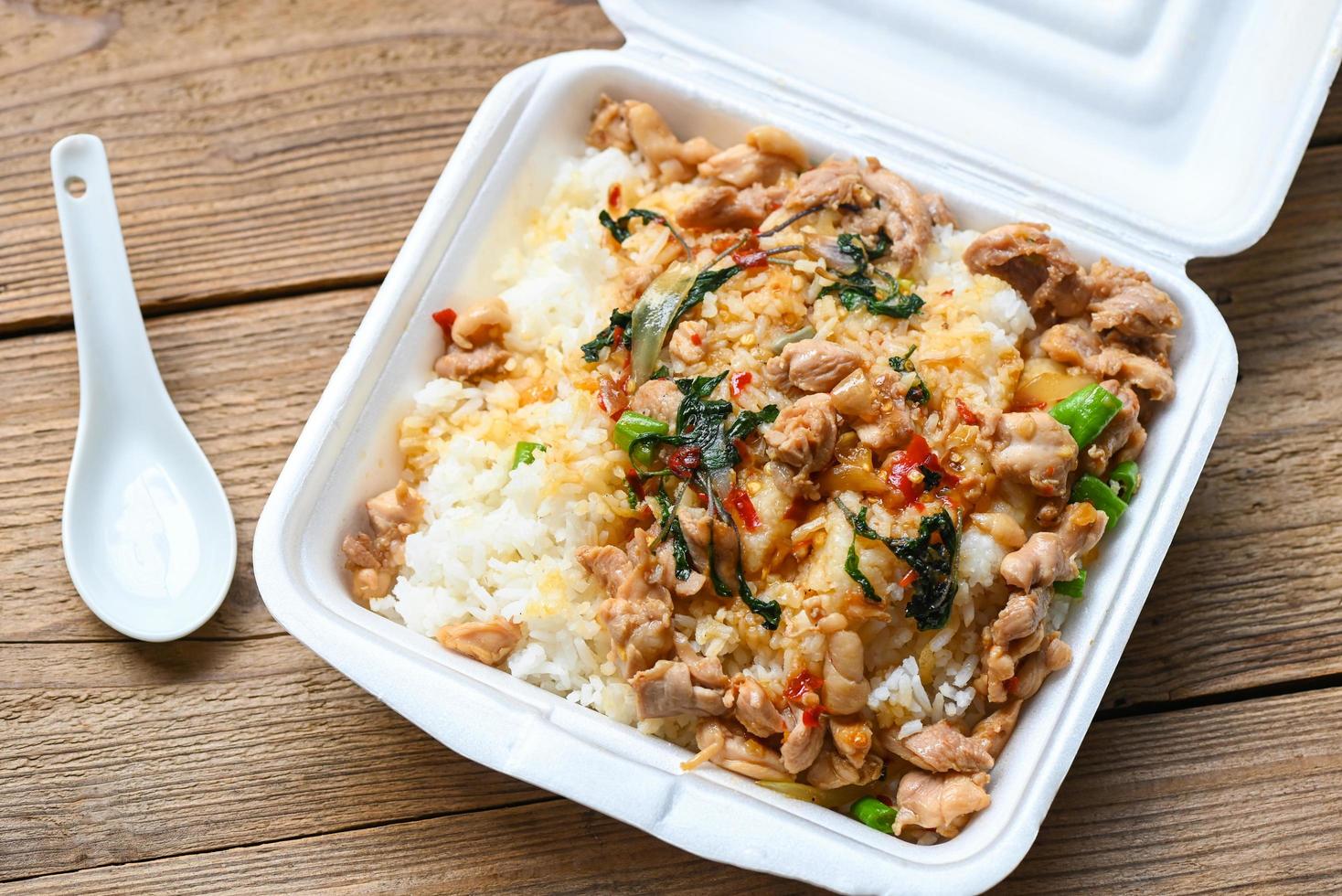 lunch box foam , food box with rice stir fried chicken with holy basil takeaway food , street food - dangerous to health waste garbage foam food concept photo