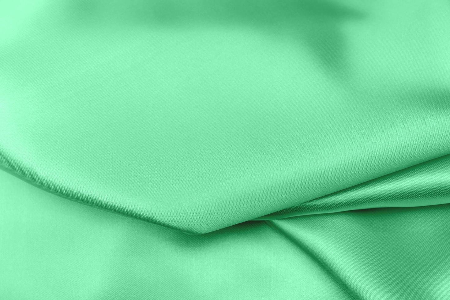 green satin fabric texture soft blur background photo