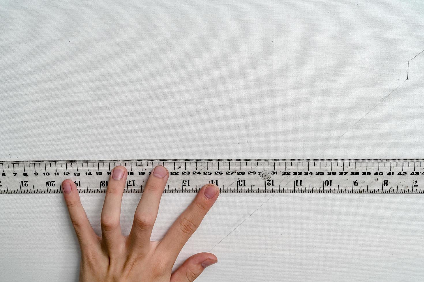 hand holding ruler with canvas background photo