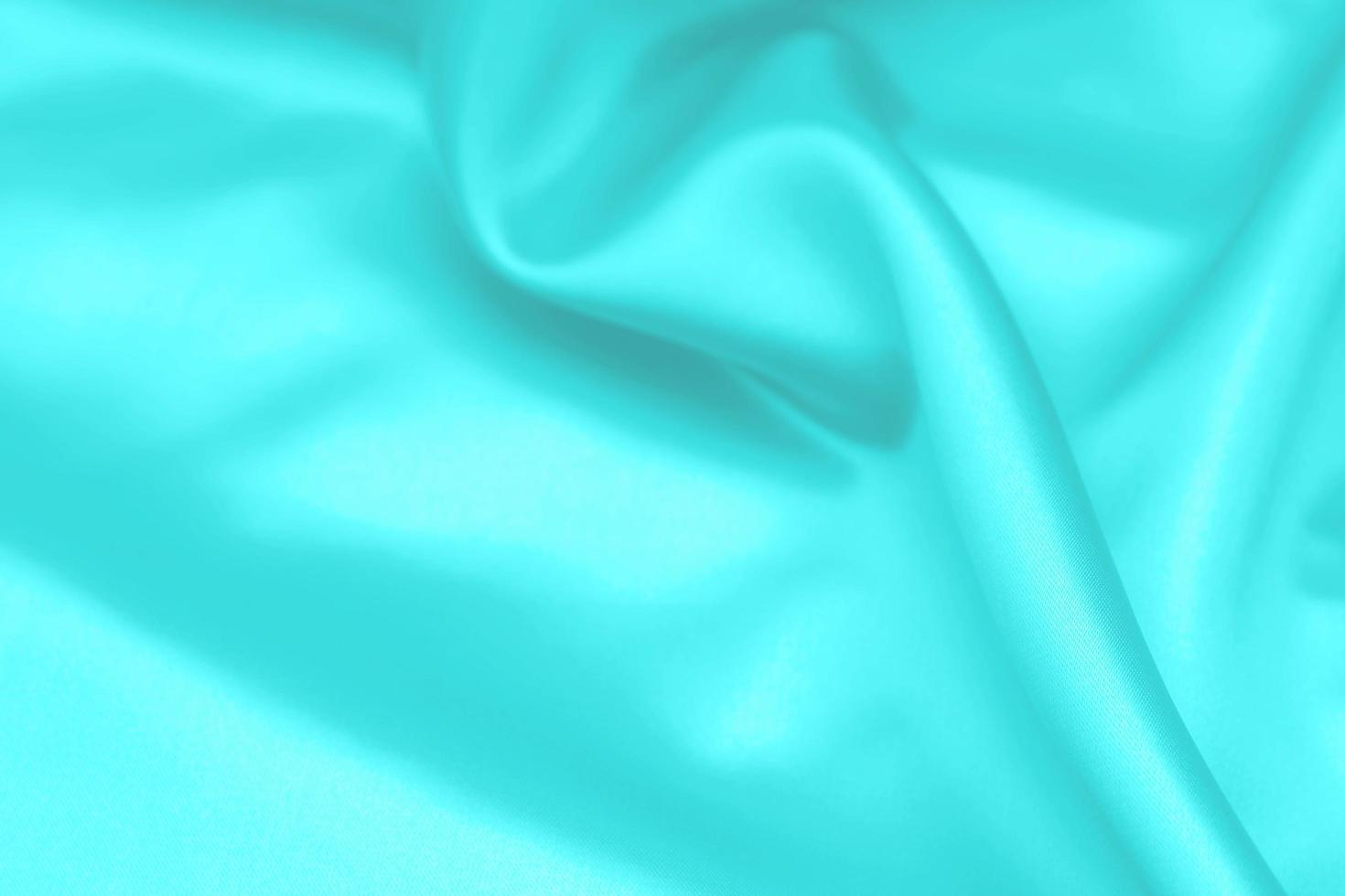 Cyan-Teal satin fabric texture soft blur background photo