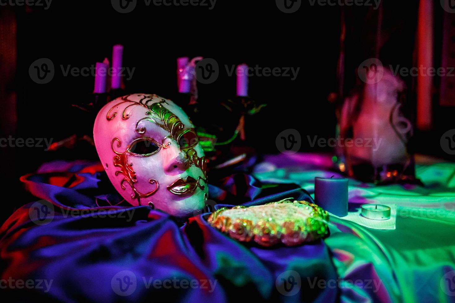 White tone Venecian carnival Mask on table  with black background photo