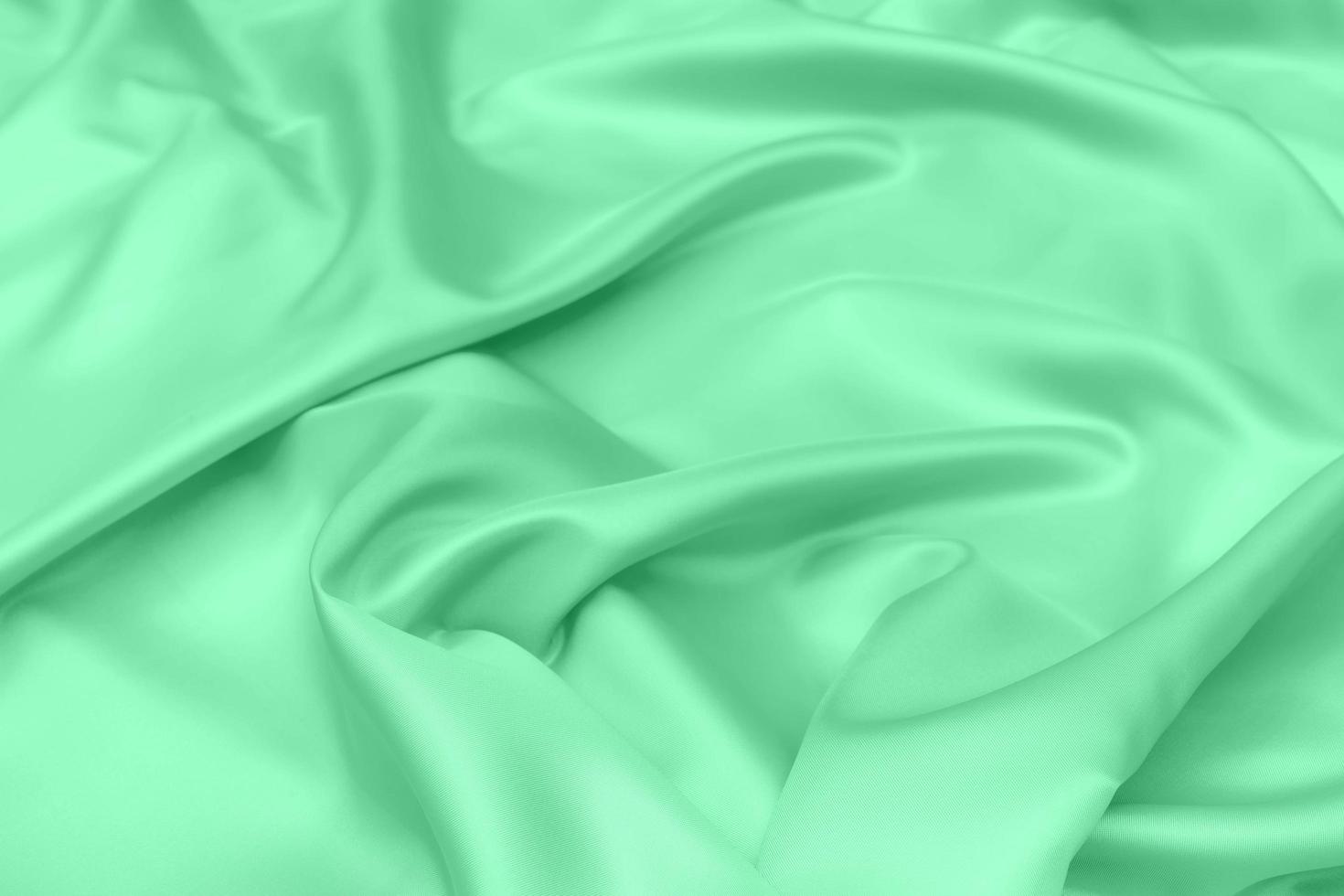 green satin fabric texture soft blur background photo