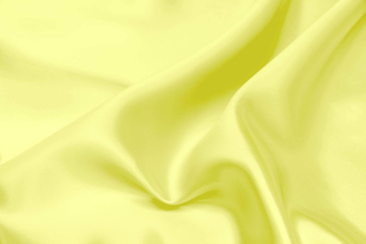Yellow satin fabric texture soft blur background photo