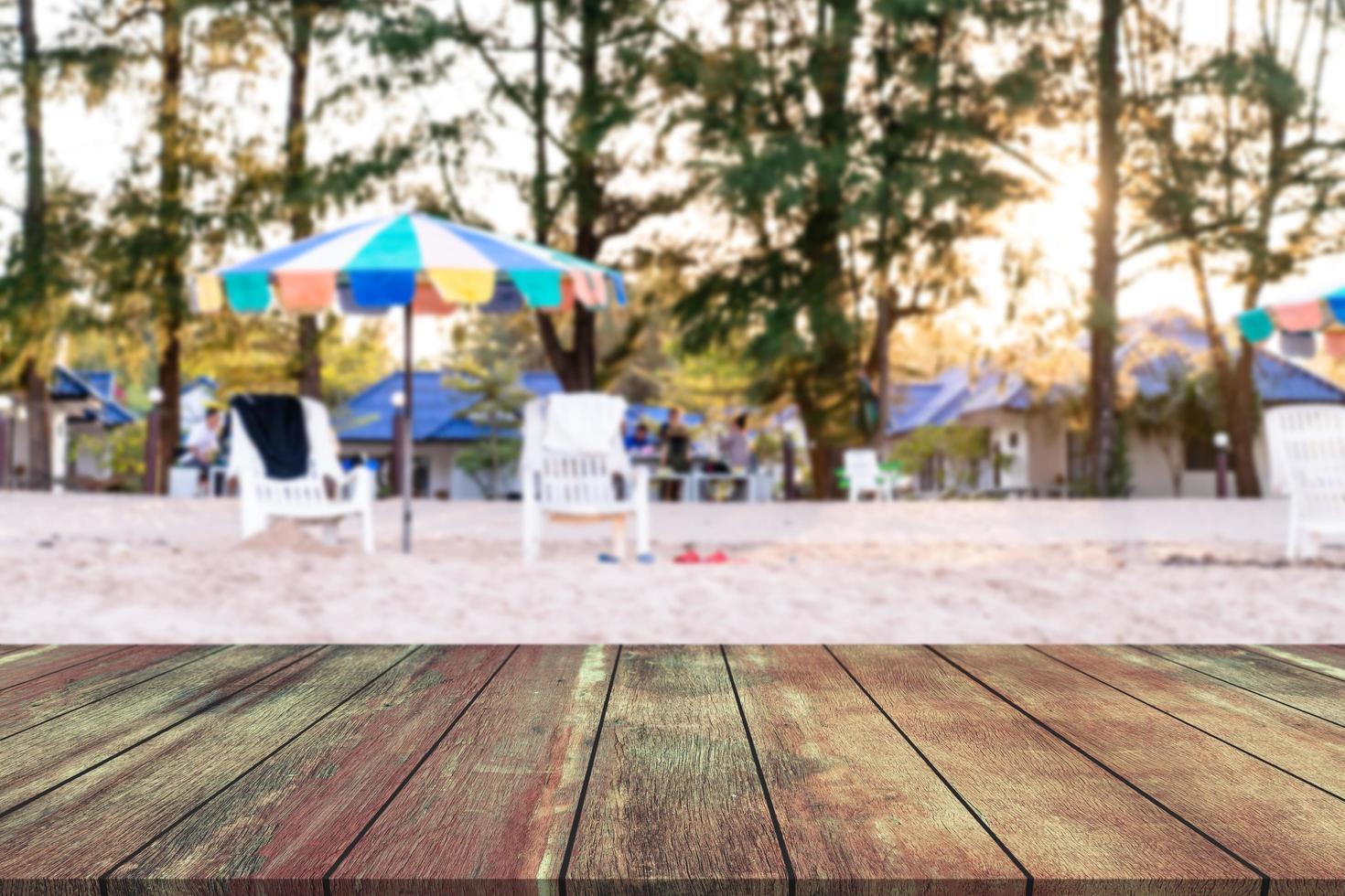 Wooden table with blur beach chair at coast background photo