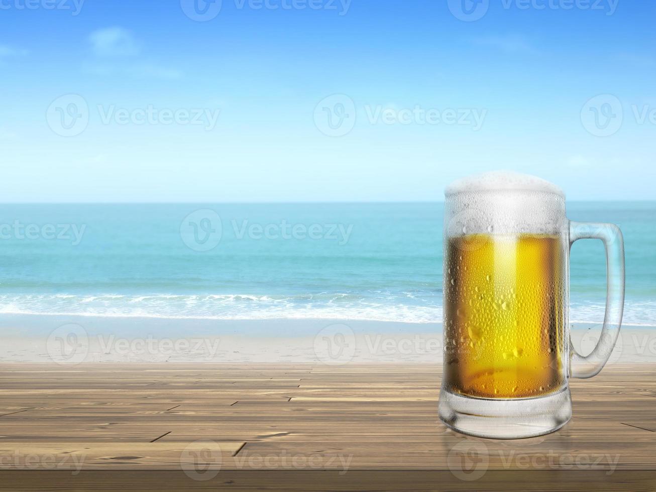 Cold beer on desk and background of summer beach photo