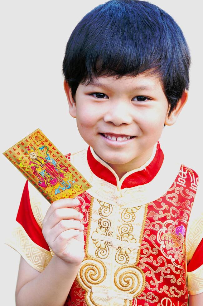 Boy is happily showing his money gift envelope in Chinese new year festival. Photo is focused at his eyes.