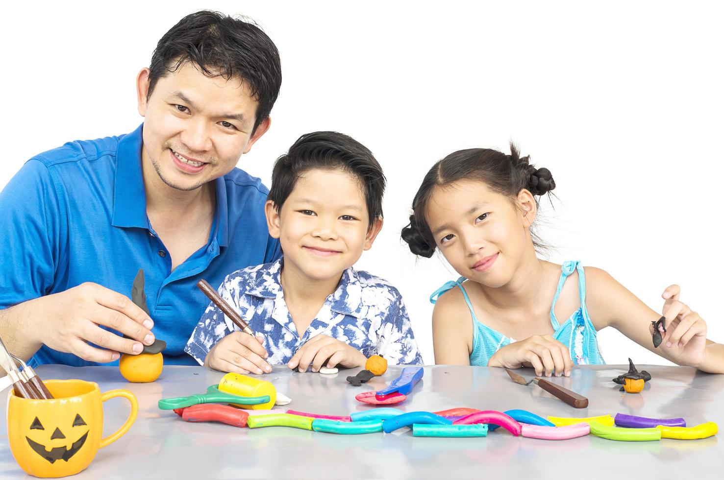 Father is playing clay toy with kid photo