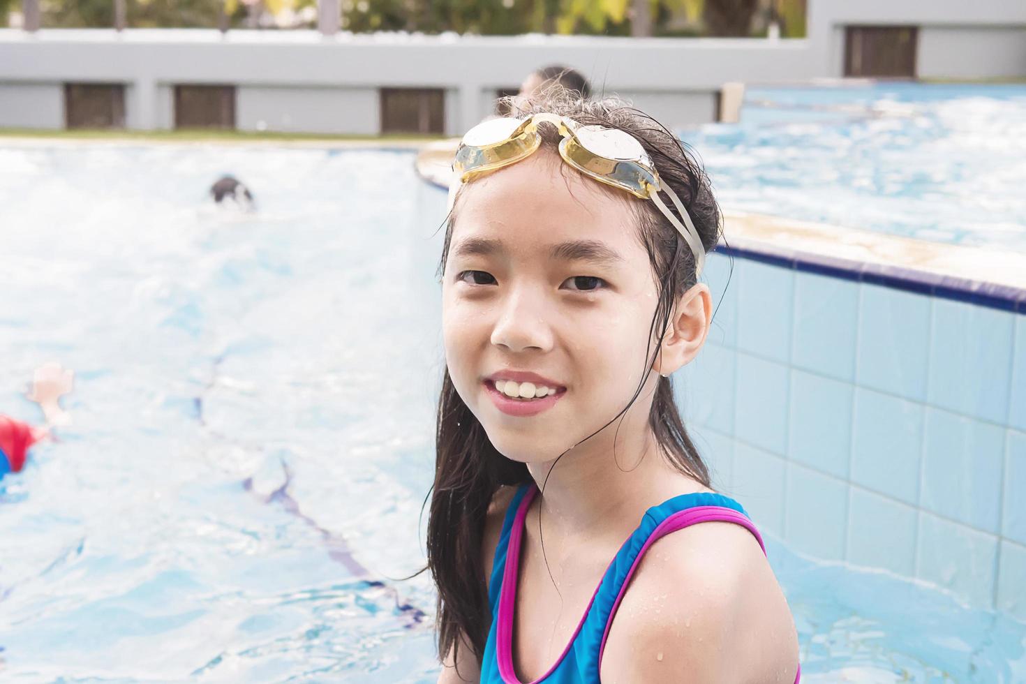 Asian happy kid at the swimming pool photo