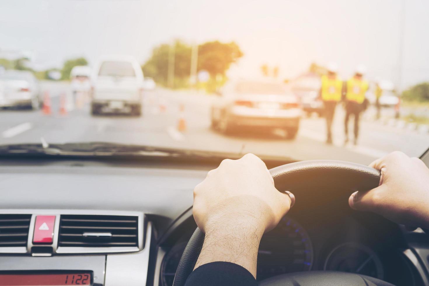 Man driving car in traffic road, left-driving countries photo