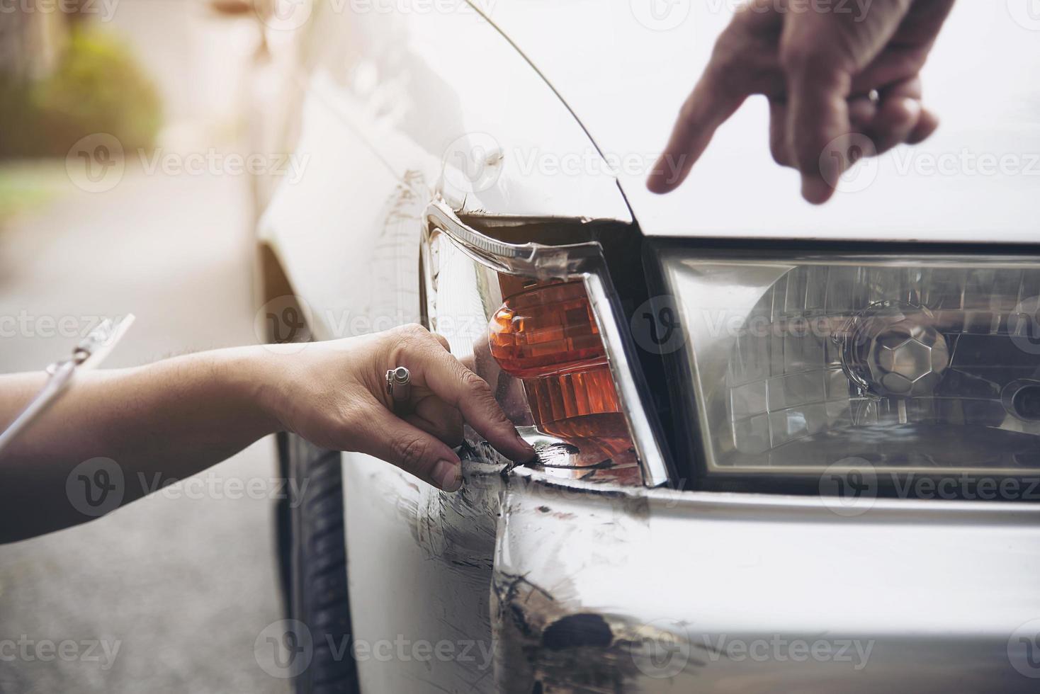 Insurance agent working during on site car accident claim process - people and car insurance claim concept photo