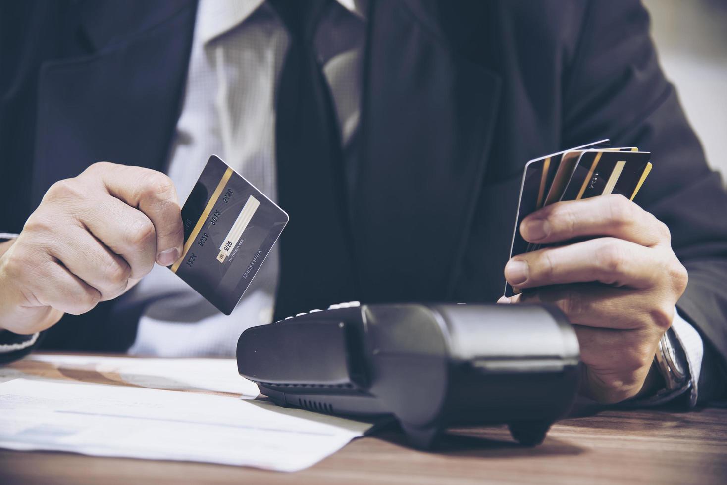 Merchant man's hand using credit card machine photo