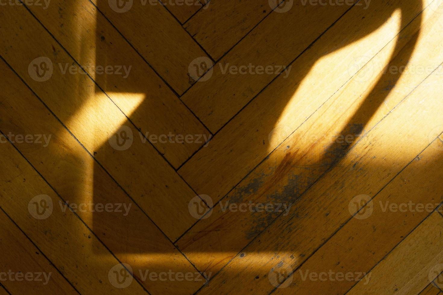 Old shabby yellow floor with sunlight shadows, horizontal photo. Background for design, wooden texture, ornament from parallel and perpendicular lines photo