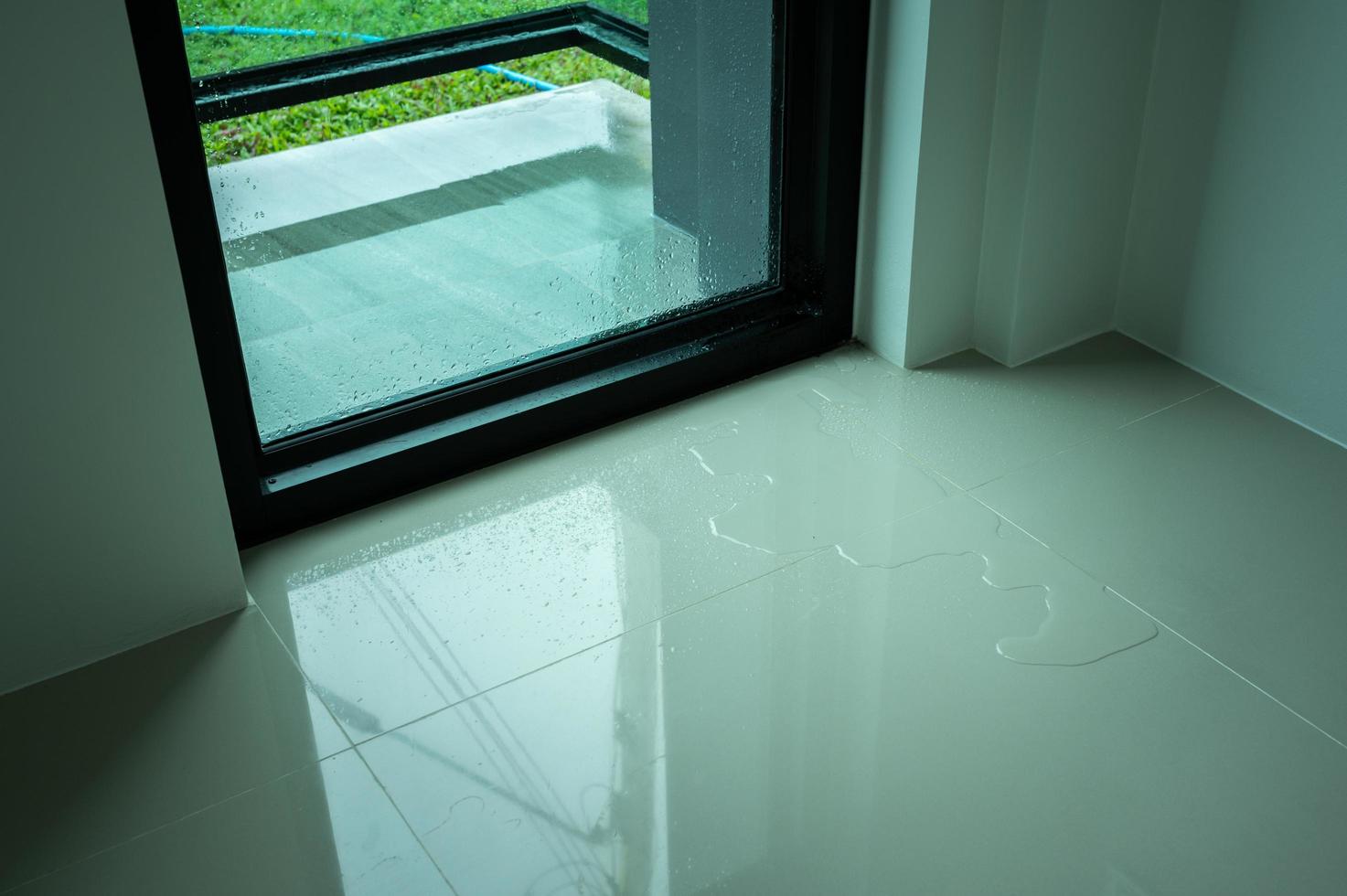 Water leaking on tile floor. Water leaks are often because of pinholes in your plumbing system or small failures in caulking or other exterior materials. photo