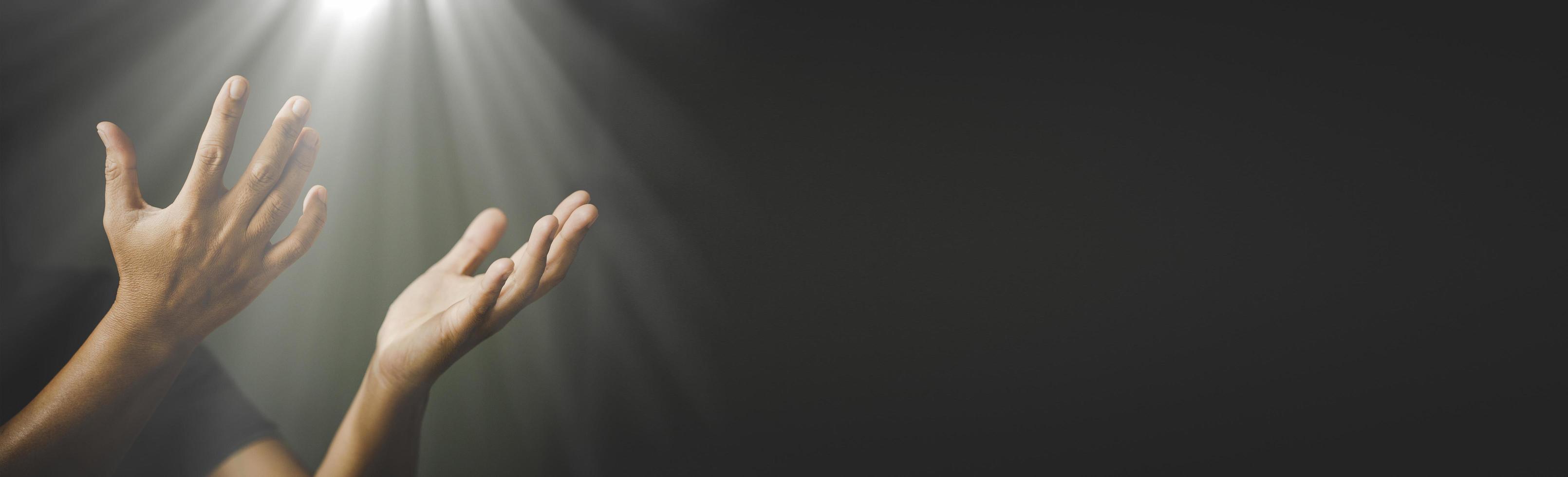 Banner image of Hands folded in prayer in church concept photo