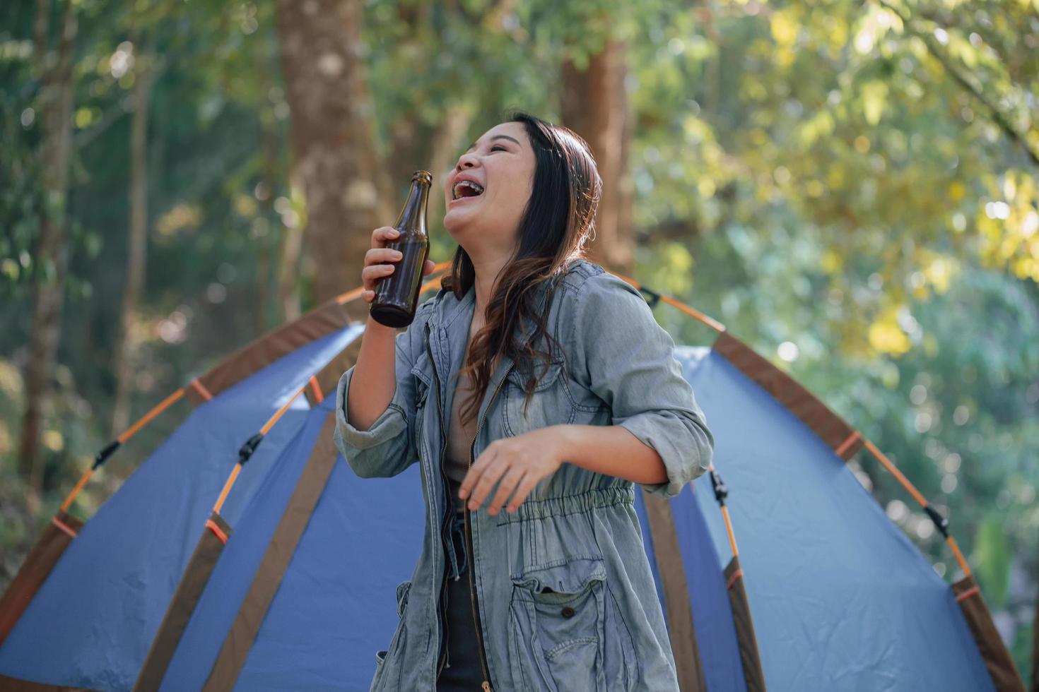 One asian beautiful woman drinking beer on camping camp photo