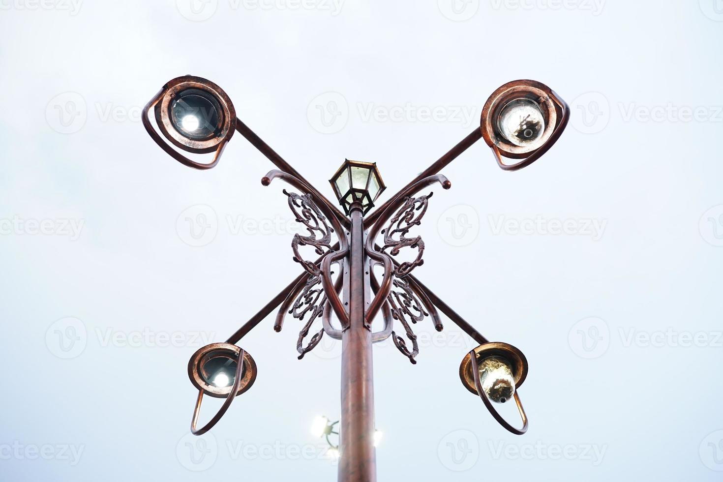 bronze garden lamp with vintage retro traditional carved design with 4 sides photo