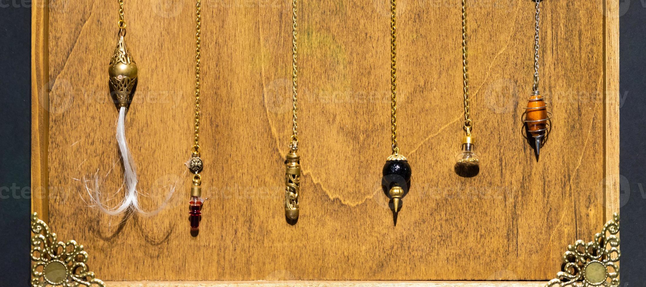 Esoteric magic pendulum. Vintage symbol of esoterism, withcraft and fortune-telling photo