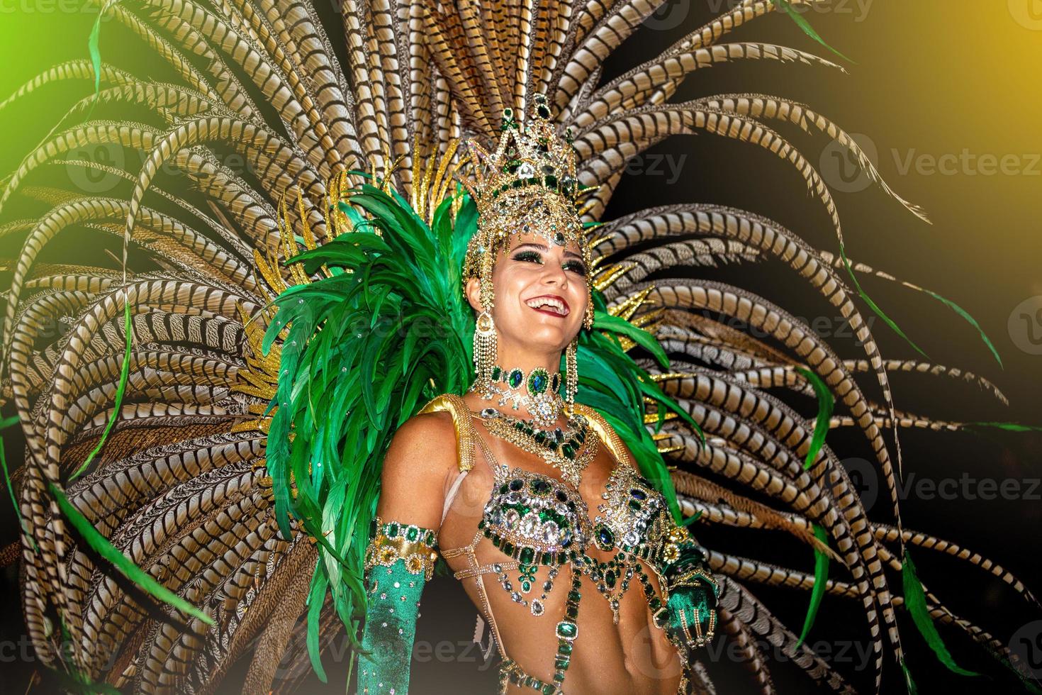 Brazilian wearing Samba Costume. Beautiful Brazilian woman wearing colorful costume and smiling during Carnaval street parade in Brazil. photo