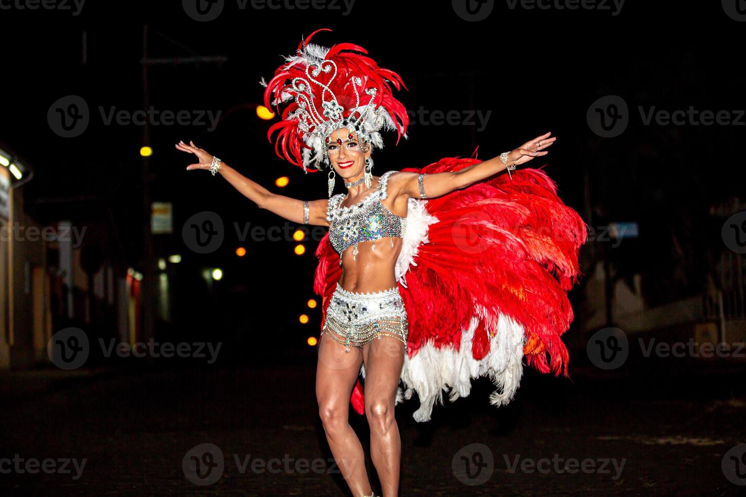 Brazilian wearing Samba Costume. Beautiful Brazilian woman wearing colorful costume and smiling during Carnaval street parade in Brazil. photo