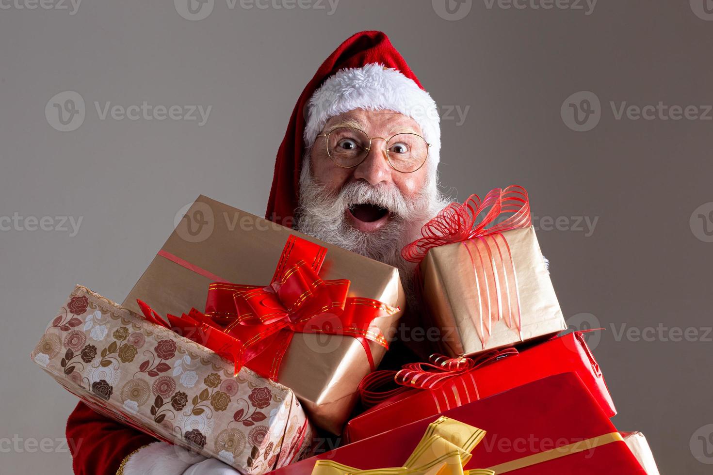 Santa Claus offering a gifts to the camera. Receiving Christmas presents. New Year parties. photo