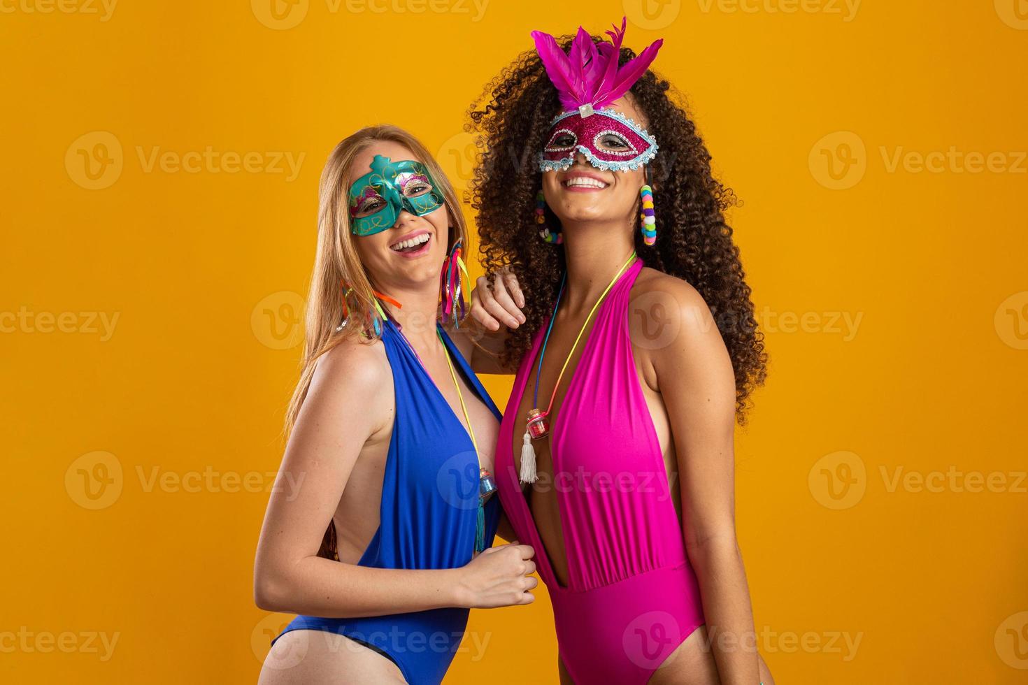 Beautiful woman dressed for carnival night. Smiling woman ready to enjoy the carnival with a colorful mask. photo