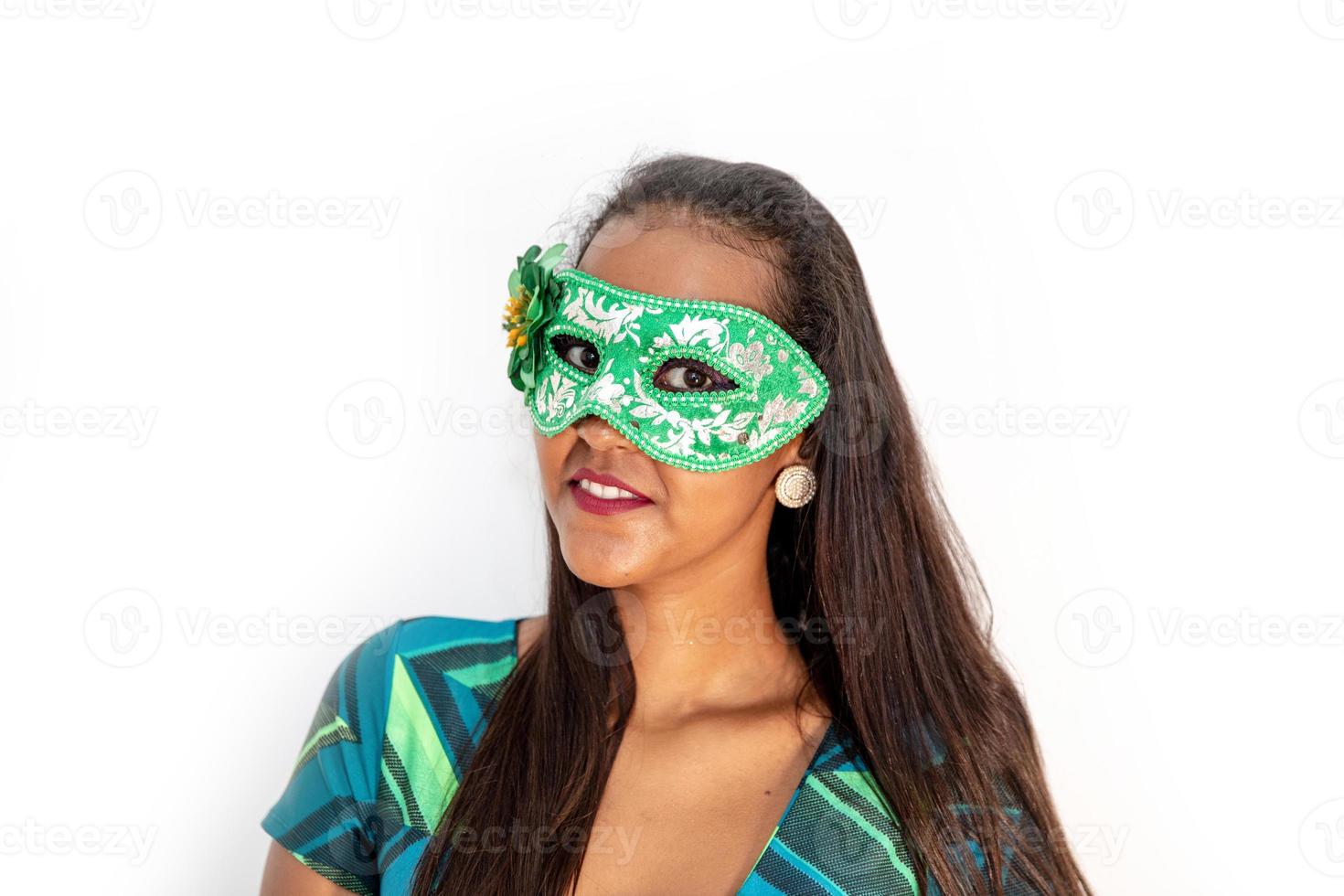 happy young woman with mask and confetti at carnaval party. Brazilian Carnival photo