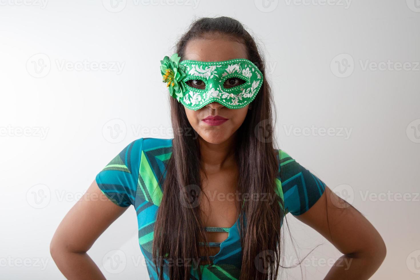 happy young woman with mask and confetti at carnaval party. Brazilian Carnival photo