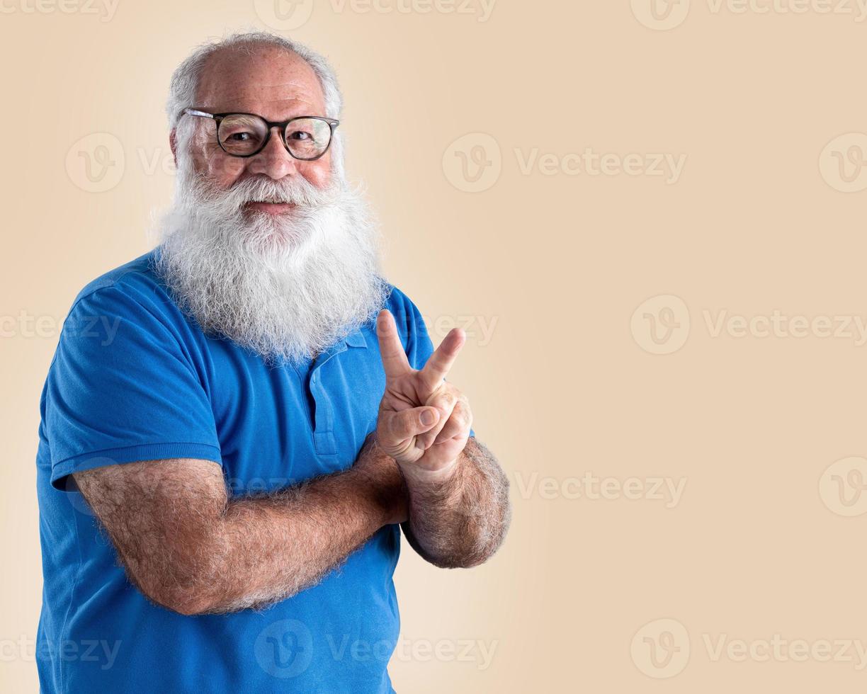 Old man with a long beard on a pastel background. Senior with full white beard. photo