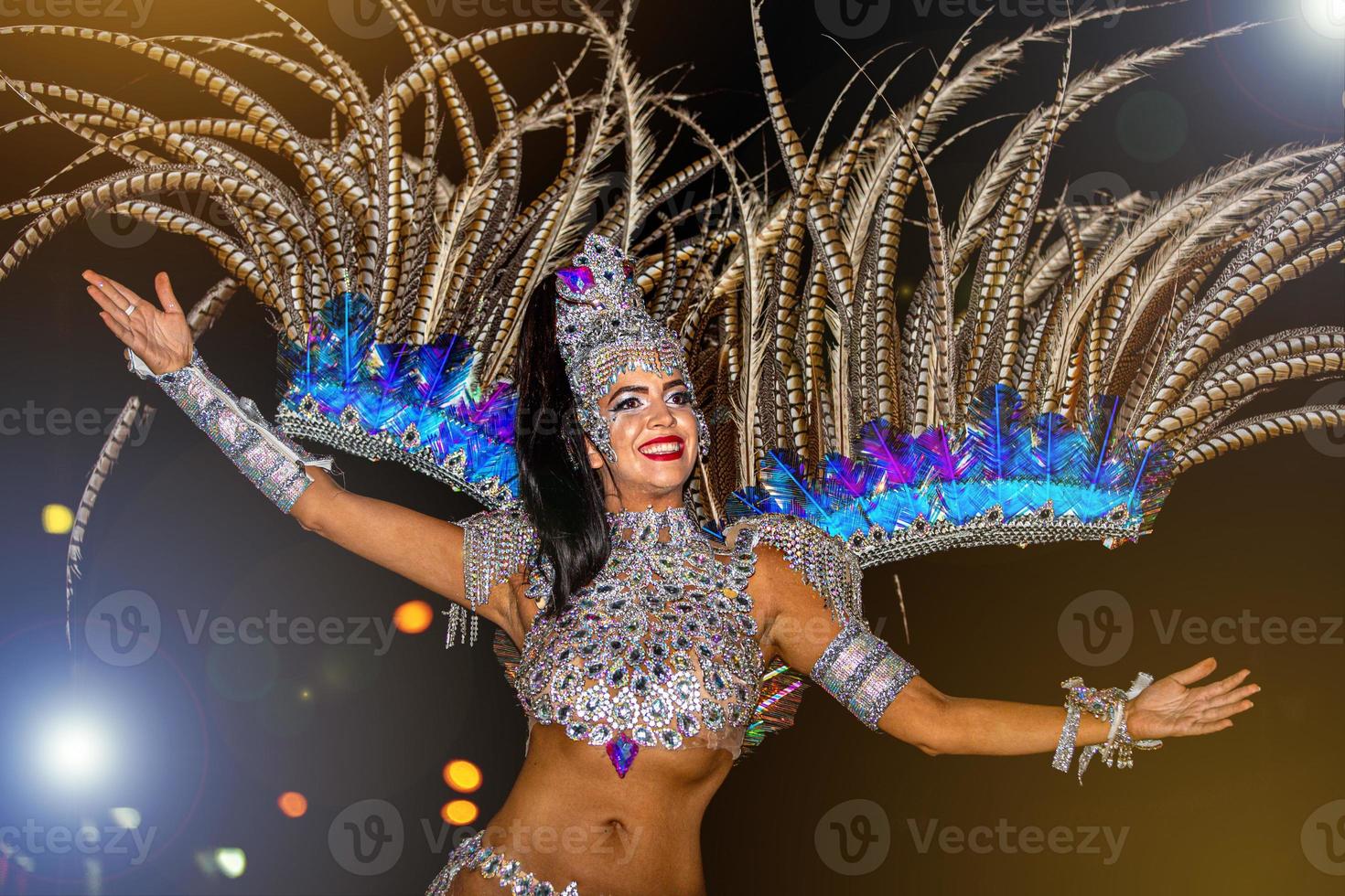 Brazilian wearing Samba Costume. Beautiful Brazilian woman wearing colorful costume and smiling during Carnaval street parade in Brazil. photo