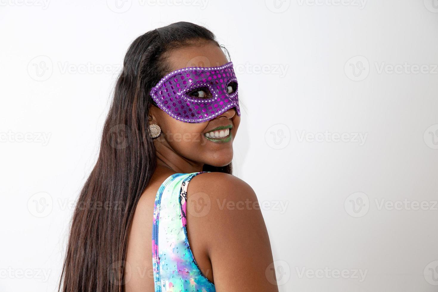 happy young woman with mask and confetti at carnaval party. Brazilian Carnival photo