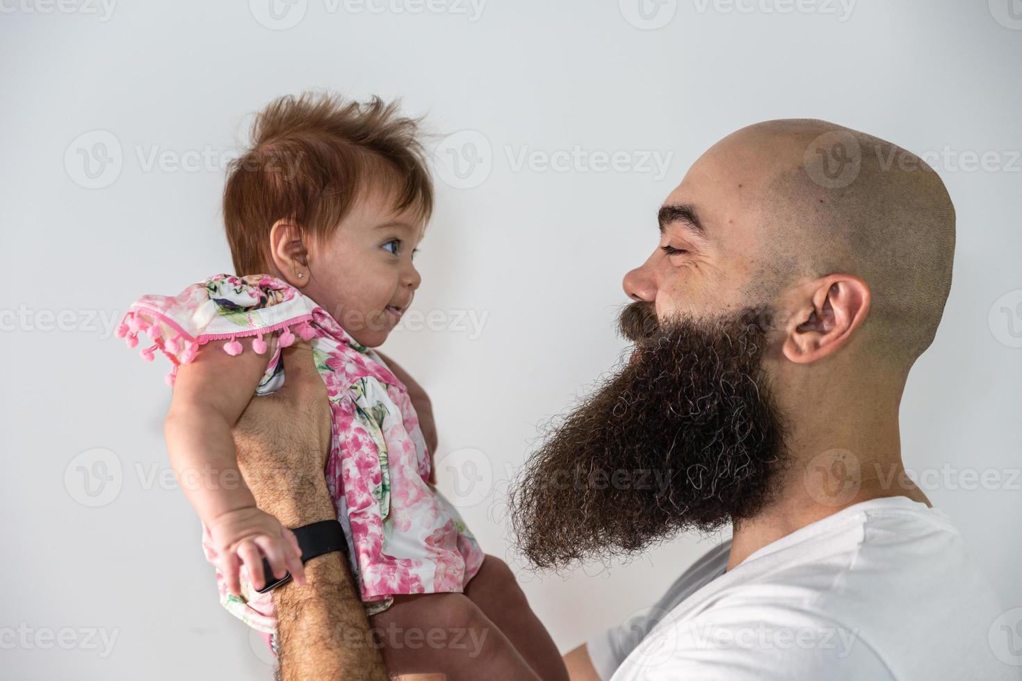 Father holding his newly born daughter in arms photo