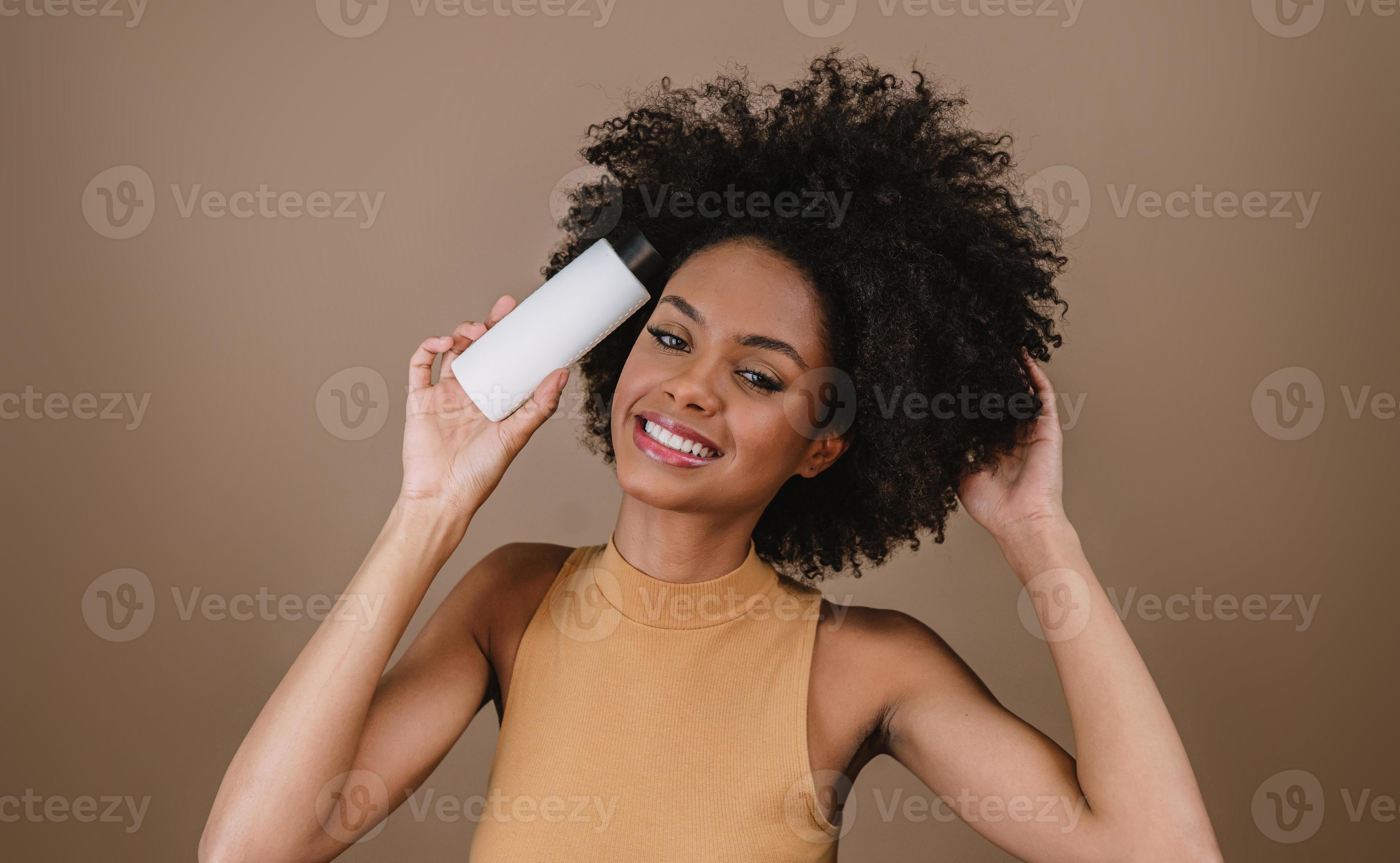 Beauty Latin woman with afro hairstyle. Brazilian woman. Holding blank shampoo packaging. Curly hair. Hair style. Pastel background. 9348757 Stock Photo at Vecteezy Beauty Latin woman with afro hairstyle. Brazilian woman. Holding blank shampoo packaging. Curly hair. Hair style. Pastel background. 9348757 Stock Photo at Vecteezy