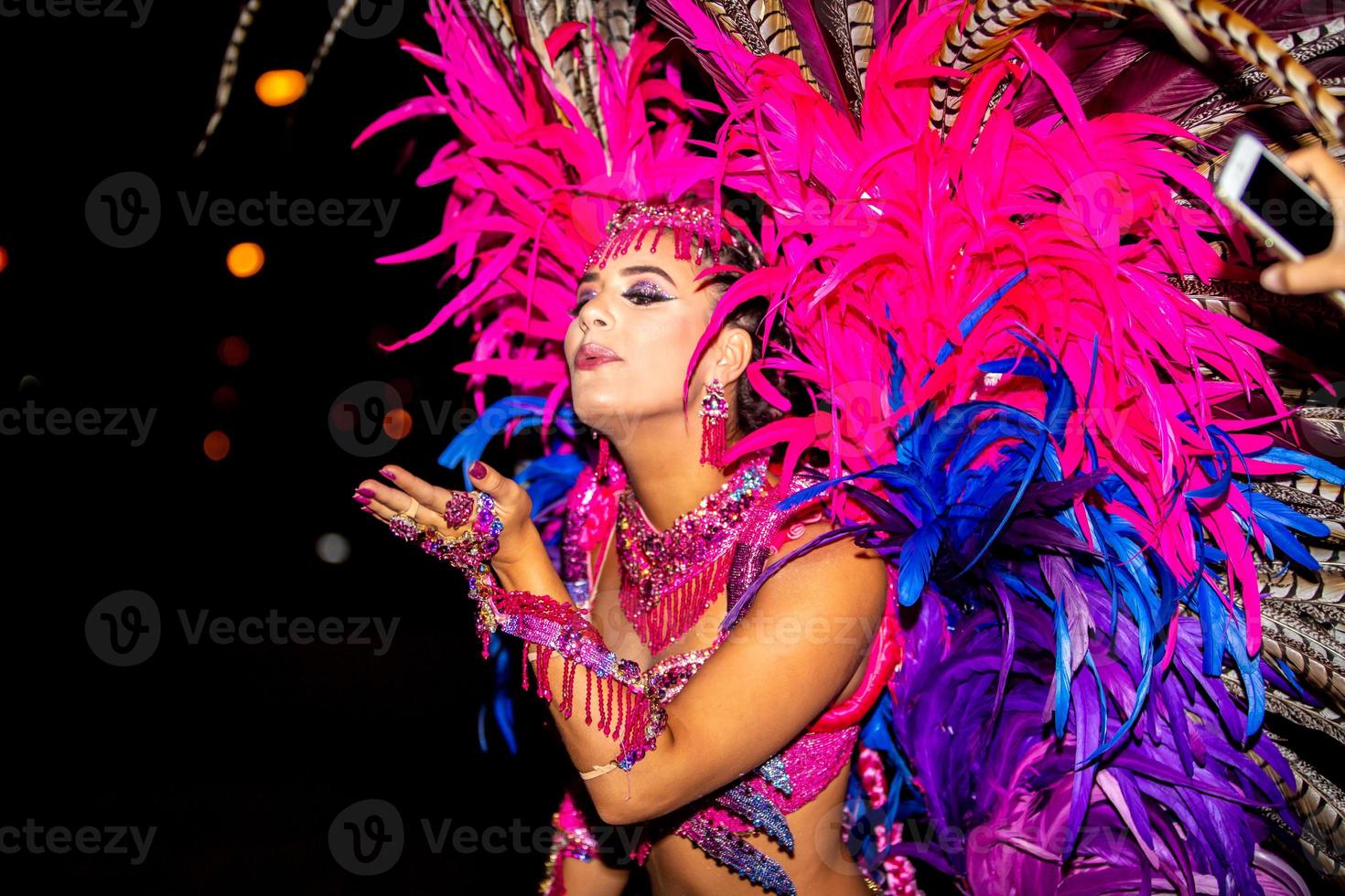 Brazilian wearing Samba Costume. Beautiful Brazilian woman wearing colorful costume and smiling during Carnaval street parade in Brazil. photo