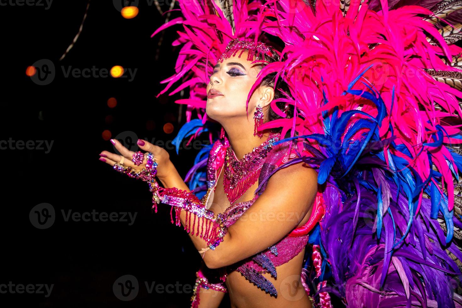 Brazilian wearing Samba Costume. Beautiful Brazilian woman wearing colorful costume and smiling during Carnaval street parade in Brazil. photo