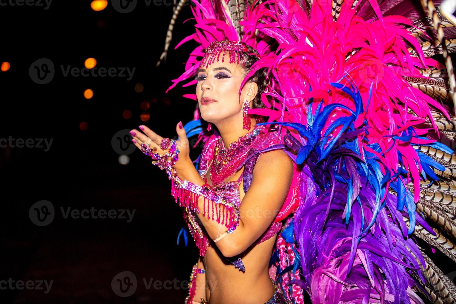 Brazilian wearing Samba Costume. Beautiful Brazilian woman wearing colorful costume and smiling during Carnaval street parade in Brazil. photo