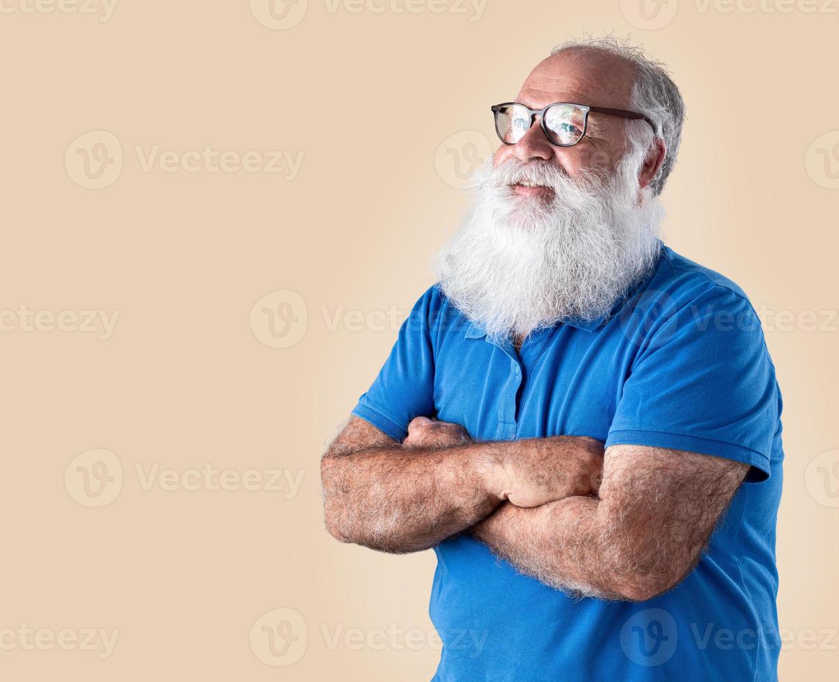 Old man with a long beard on a pastel background. Senior with full white beard. photo