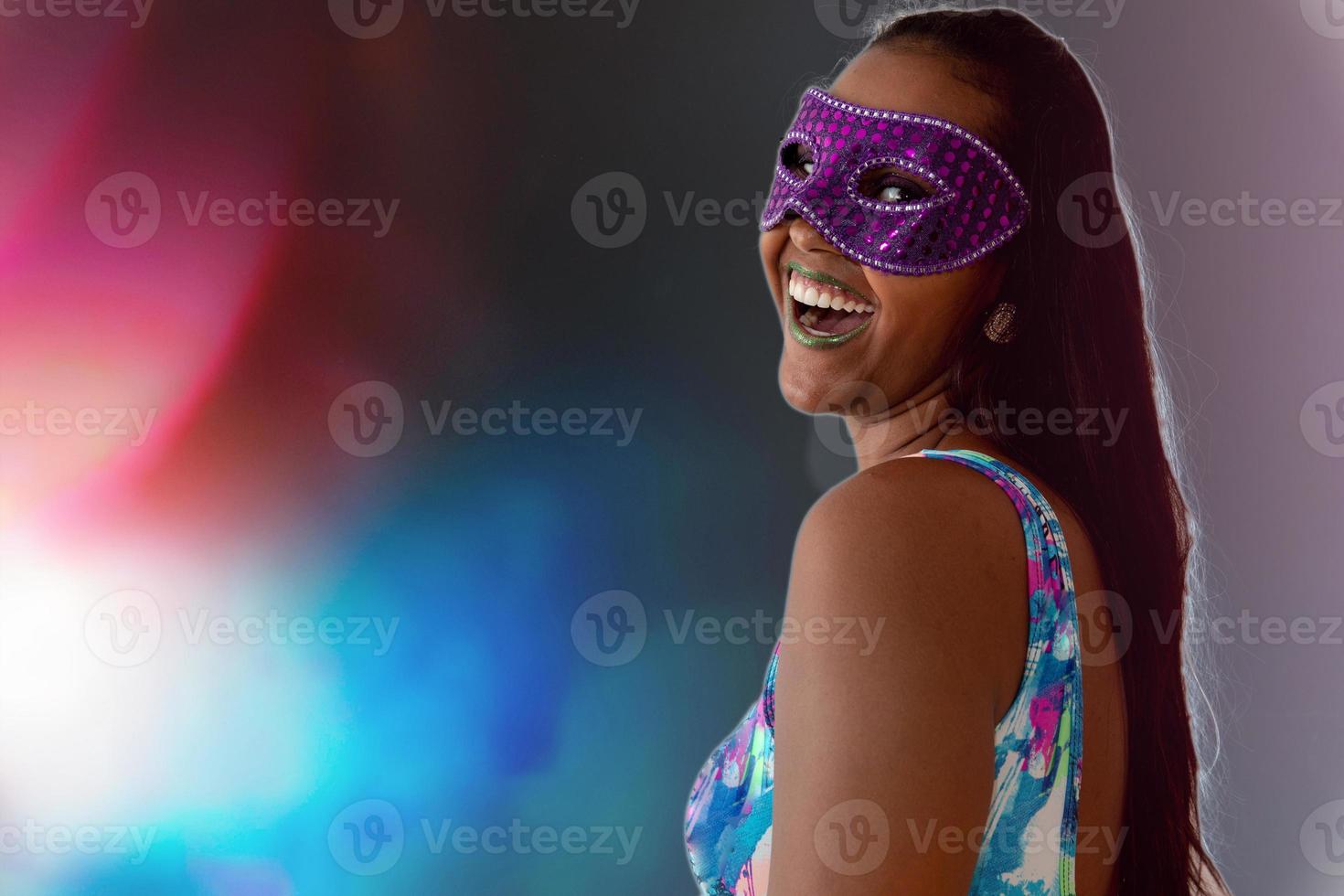 happy young woman with mask and confetti at carnaval party. Brazilian Carnival photo