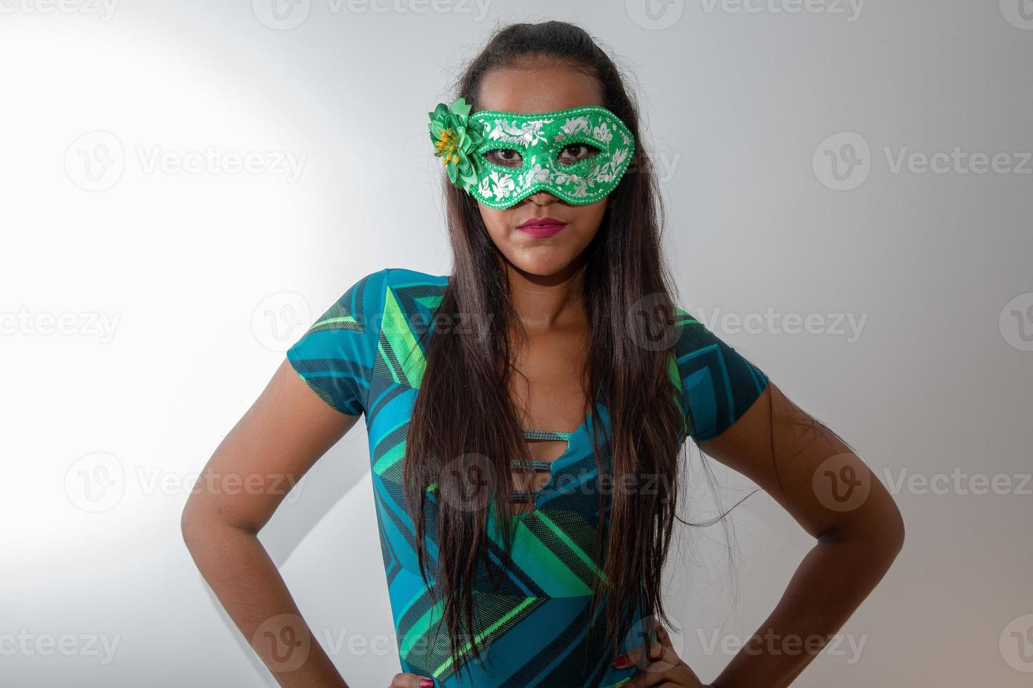 happy young woman with mask and confetti at carnaval party. Brazilian Carnival photo